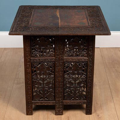 Lot 566 - An Anglo-Indian carved hardwood folding table together with a matching three-fold small screen