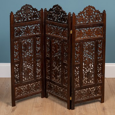 Lot 566 - An Anglo-Indian carved hardwood folding table together with a matching three-fold small screen