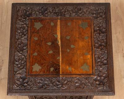 Lot 566 - An Anglo-Indian carved hardwood folding table together with a matching three-fold small screen