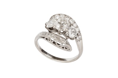 Lot 56 - A diamond crossover dress ring, centred with a...