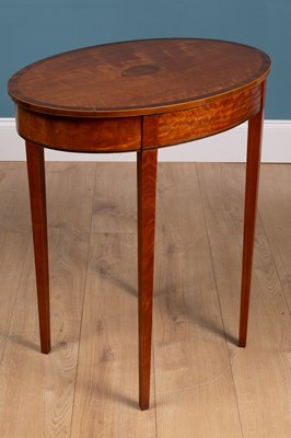 Lot 487 - An antique satinwood oval lamp table