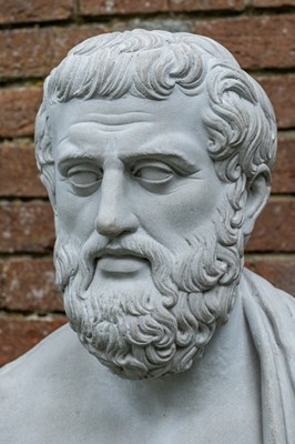 Lot 1343 - A cast reconstituted bust of Aristotle on a matching fluted plinth
