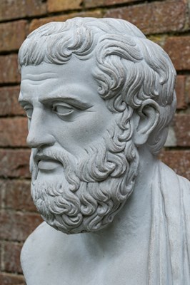 Lot 1343 - A cast reconstituted bust of Aristotle on a matching fluted plinth