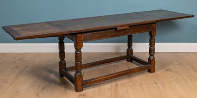 Lot 443 - An old oak drawer leaf dining table