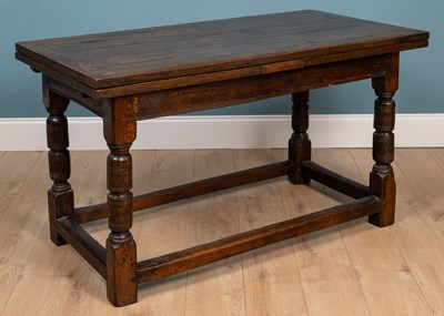 Lot 443 - An old oak drawer leaf dining table