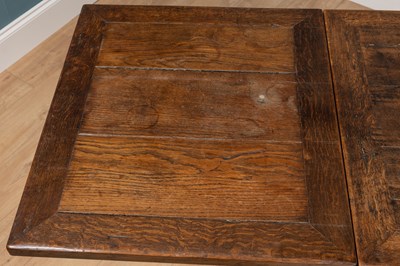 Lot 443 - An old oak drawer leaf dining table