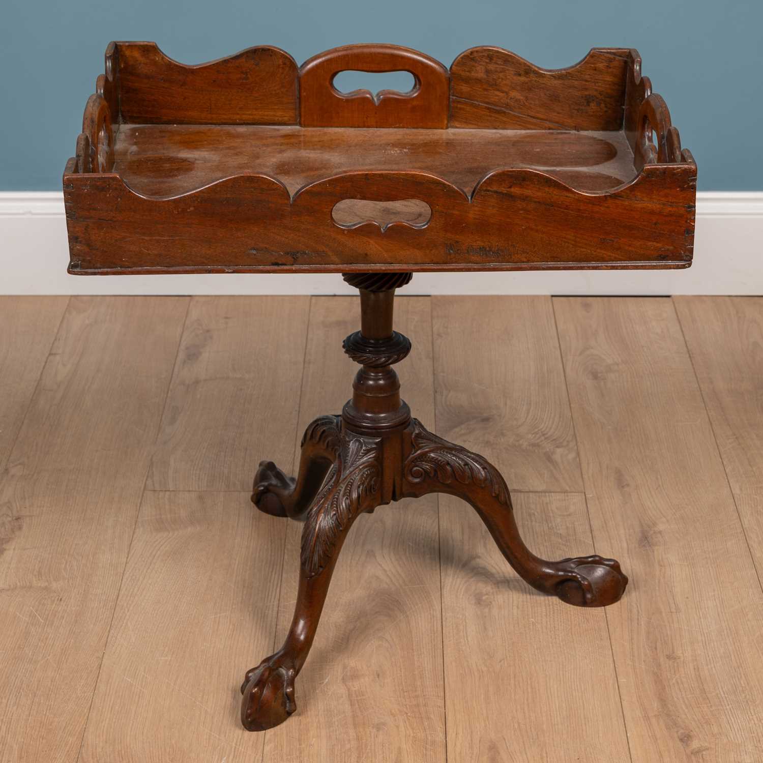 Lot 41 - An occasional table with a galleried rectangular tray-top and pierced carrying handles