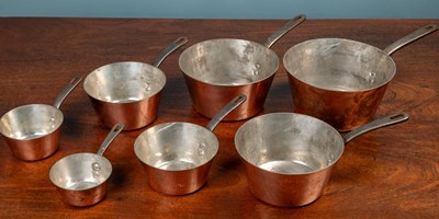 Lot 359 - A set of seven graduated copper saucepans