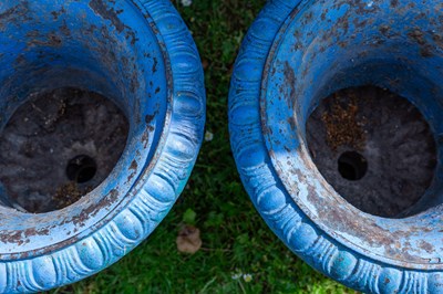 Lot 1322 - A pair of old blue painted cast iron garden urns