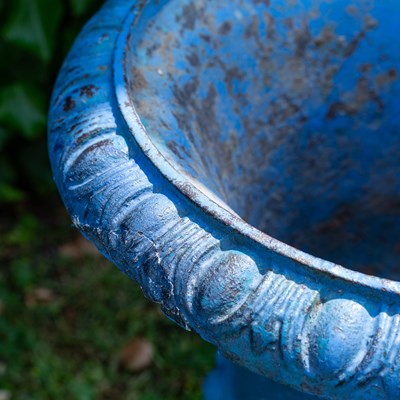 Lot 1322 - A pair of old blue painted cast iron garden urns