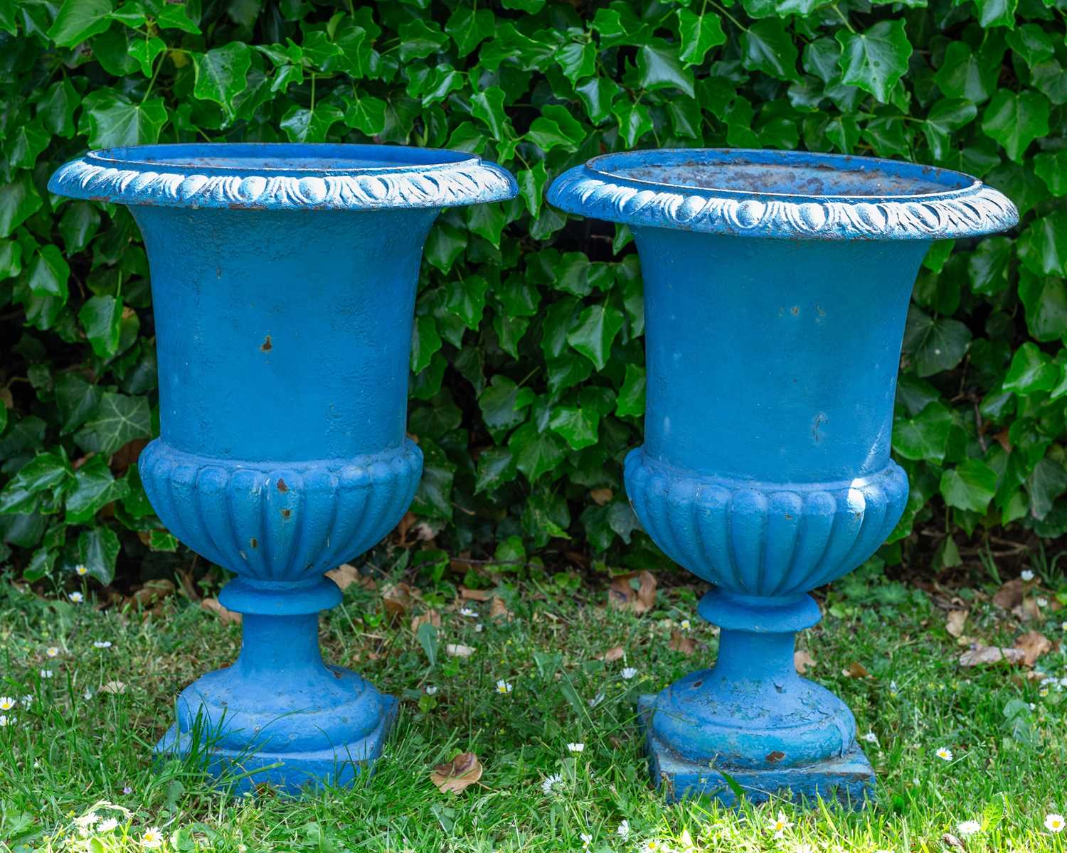 Lot 1322 - A pair of old blue painted cast iron garden urns