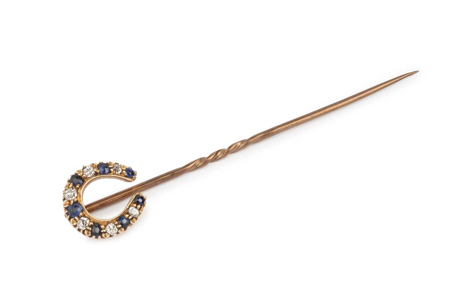 Lot 96 - A sapphire and diamond set stick pin, modelled...