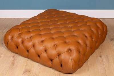 Lot 292 - A contemporary leather, button-upholstered ottoman stool