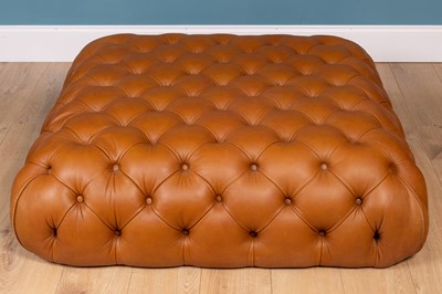 Lot 292 - A contemporary leather, button-upholstered ottoman stool