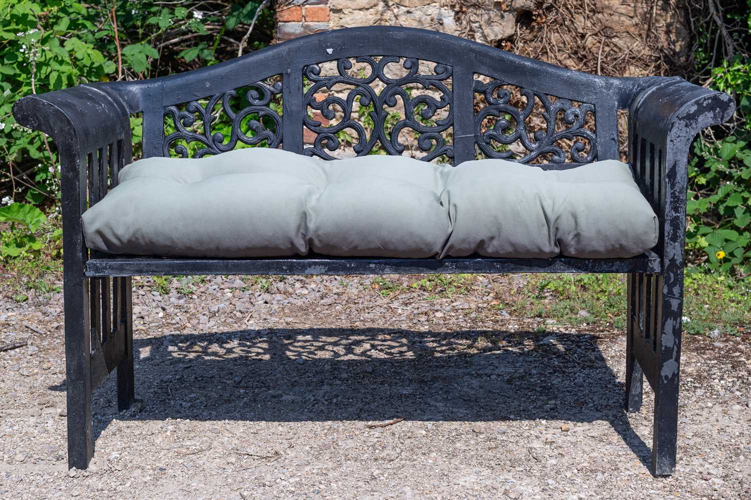 Lot 215 - A black painted cast aluminium garden bench