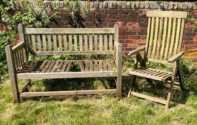 Lot 1243 - A teak garden bench together with a folding garden chair