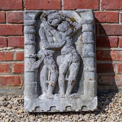 Lot 1247 - A weathered cast reconstituted stone carving depicting two figures