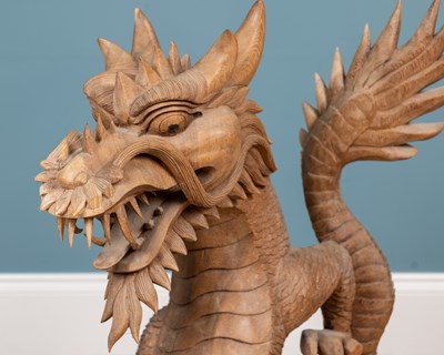 Lot 1314 - A carved Oriental hardwood sculpture of a dragon