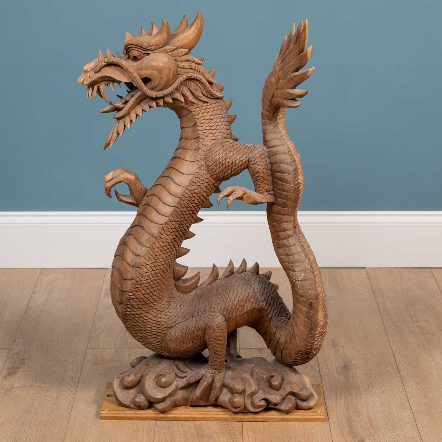 Lot 1314 - A carved Oriental hardwood sculpture of a dragon
