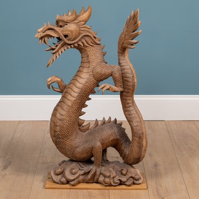 Lot 1314 - A carved Oriental hardwood sculpture of a dragon