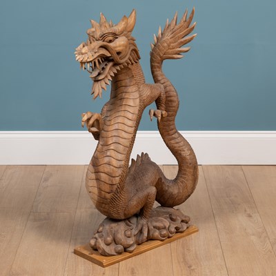 Lot 1314 - A carved Oriental hardwood sculpture of a dragon