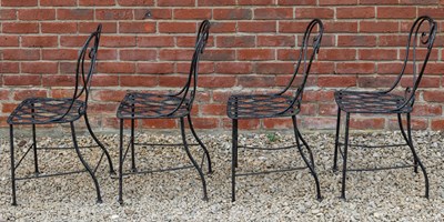 Lot 1309 - A set of four black painted wrought iron garden chairs