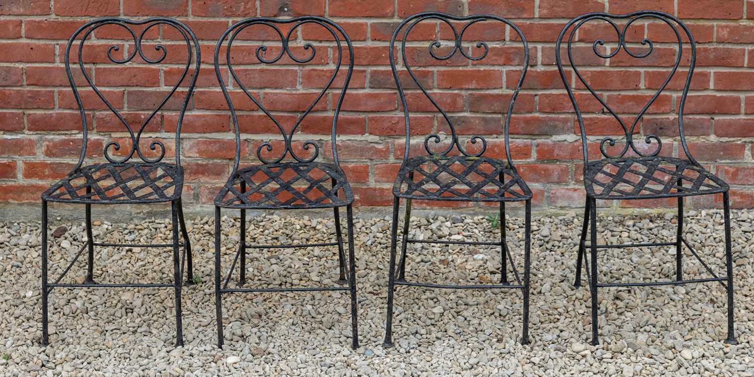 Lot 1309 - A set of four black painted wrought iron garden chairs