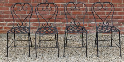 Lot 1309 - A set of four black painted wrought iron garden chairs