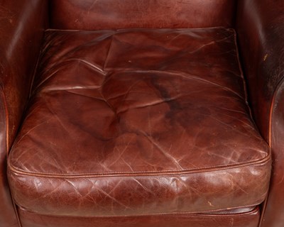 Lot 46 - A contemporary marron leather upholstered wing back armchair