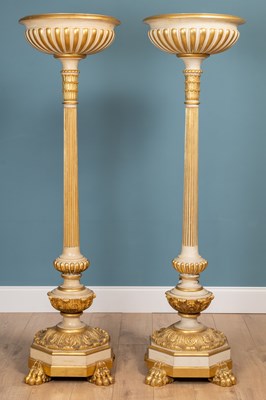 Lot 497 - A pair of large painted and giltwood uplighters