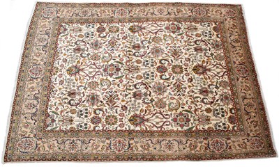 Lot 1054 - A cream ground Oriental rug