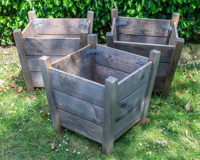 Lot 1286 - A set of three square tapering garden planters