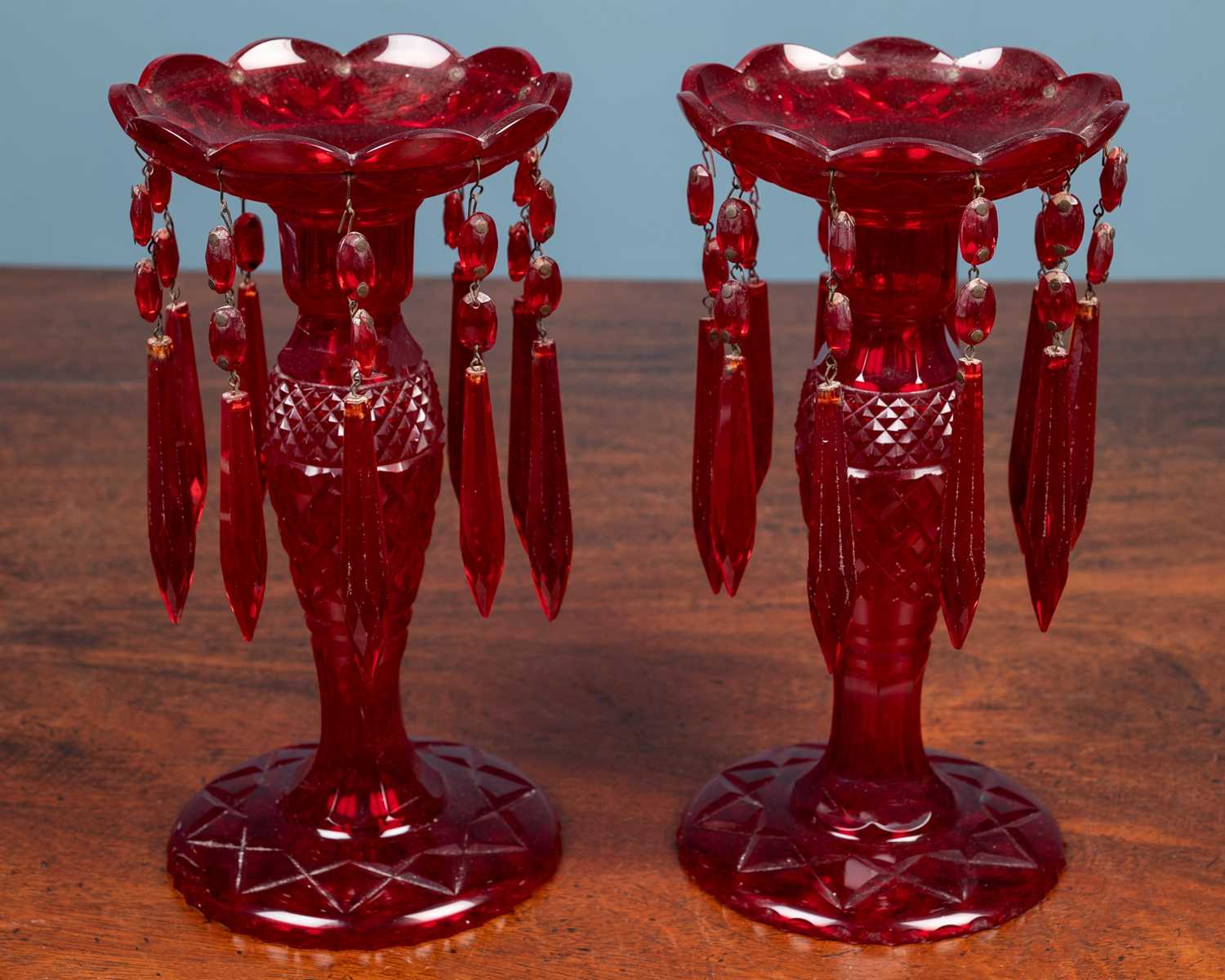 Lot 156 - A pair of ruby glass lustres