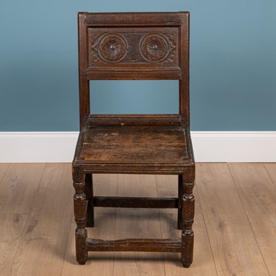 Lot 411 - A 17th century oak high-backed stool or chair