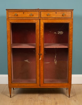 Lot 18 - A George III Sheraton style satinwood library cabinet
