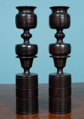 Lot 181 - A pair of decorative turned ebony candlesticks
