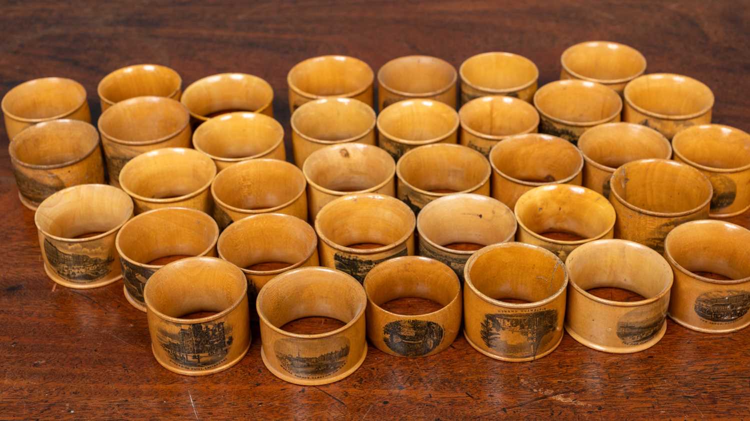 Lot 87 - A collection of thirty five 19th century and later turned Mauchline ware napkin rings