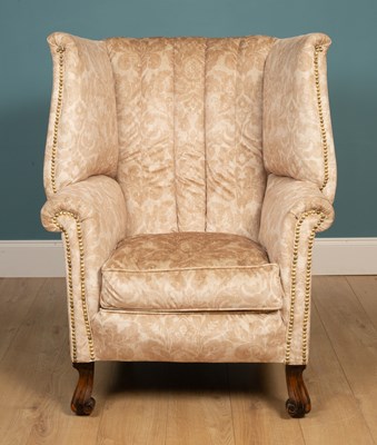 Lot 327 - A Georgian style wing back armchair