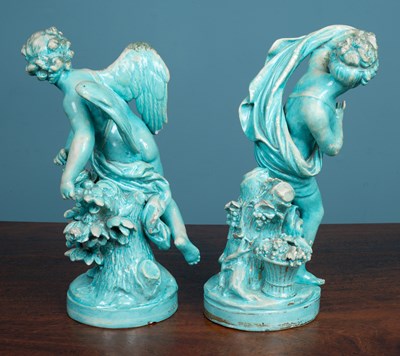 Lot 7 - A pair of Continental turquoise glazed pottery figures of Cupid and Psyche