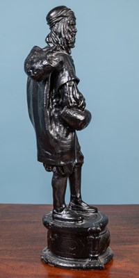 Lot 13 - A bronzed resin figure of a Bedouin man walking with a stick