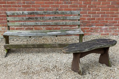 Lot 1244 - A teak garden bench together with a rough cut garden table