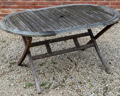 Lot 1266 - A folding teak garden dining table with a set of six matching folding chairs