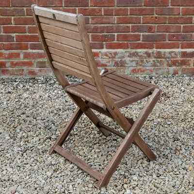 Lot 1266 - A folding teak garden dining table with a set of six matching folding chairs