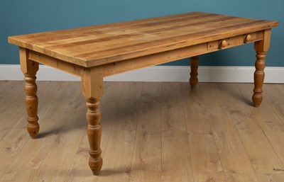 Lot 335 - A modern pine kitchen table with a single...