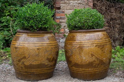 Lot 1319 - A group of four large Chinese stoneware ovoid planters