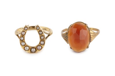 Lot 16 - Two gem set dress rings, the first modelled as...