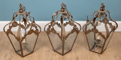 Lot 520 - A set of three gold painted wrought iron hanging lanterns