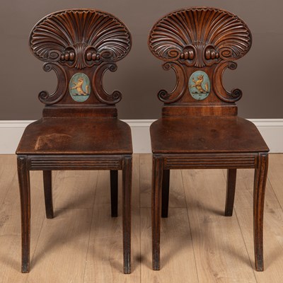 Lot 326 - A pair of early Victorian mahogany armorial shell back hall chairs