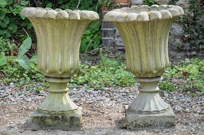 Lot 1237 - A pair of tulip shaped cast reconstituted stone garden urns