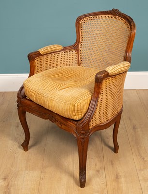 Lot 96 - A French carved walnut bergère armchair; together with a French carved walnut dressing table stool
